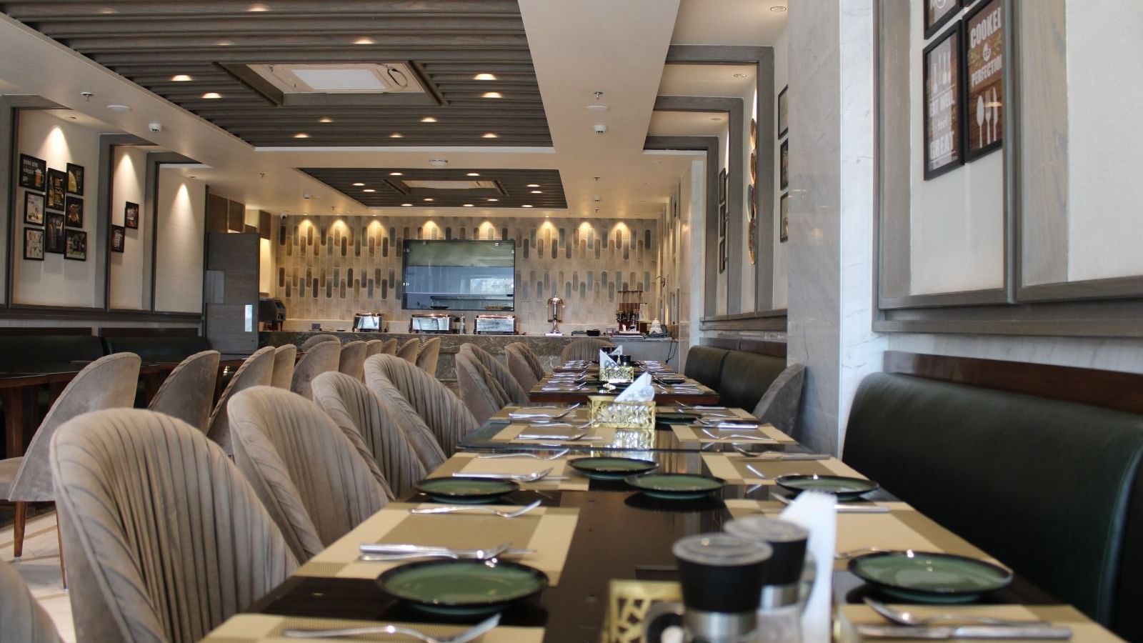 A well-arranged dining space featuring tables with chairs and neatly set cutlery at  BluSalzz Residence, Amritsar